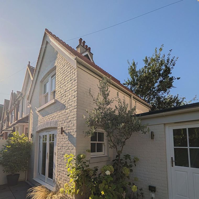 Wider view of the annex showing the sash windows, French doors and entrance door together